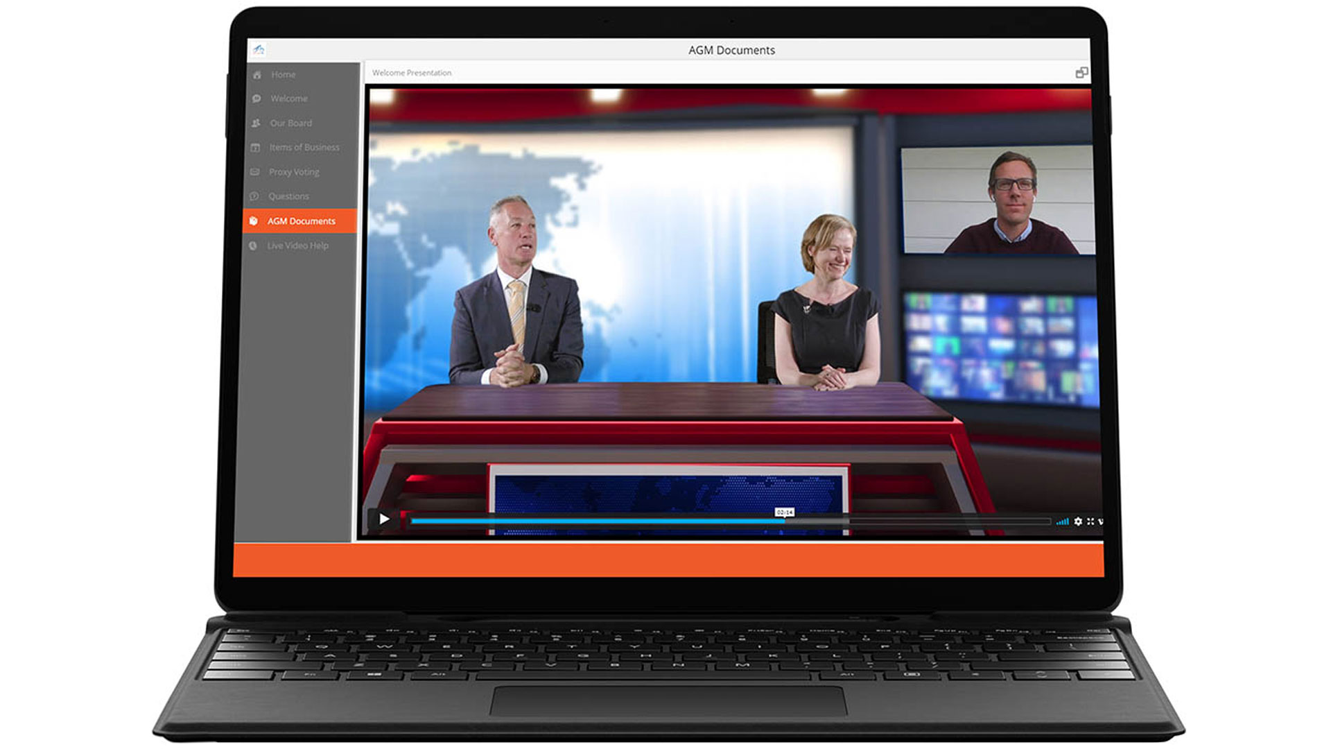 A laptop screen displays a video conference with two people seated at a news desk and a third person in a separate window. The interface shows a menu on the left and the video is paused.