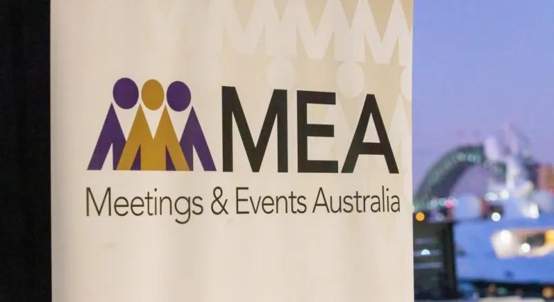 A banner displays the logo for MEA, Meetings & Events Australia, with stylized figures in purple and yellow on the left and blurred cityscape including Sydney Harbour Bridge in the background.