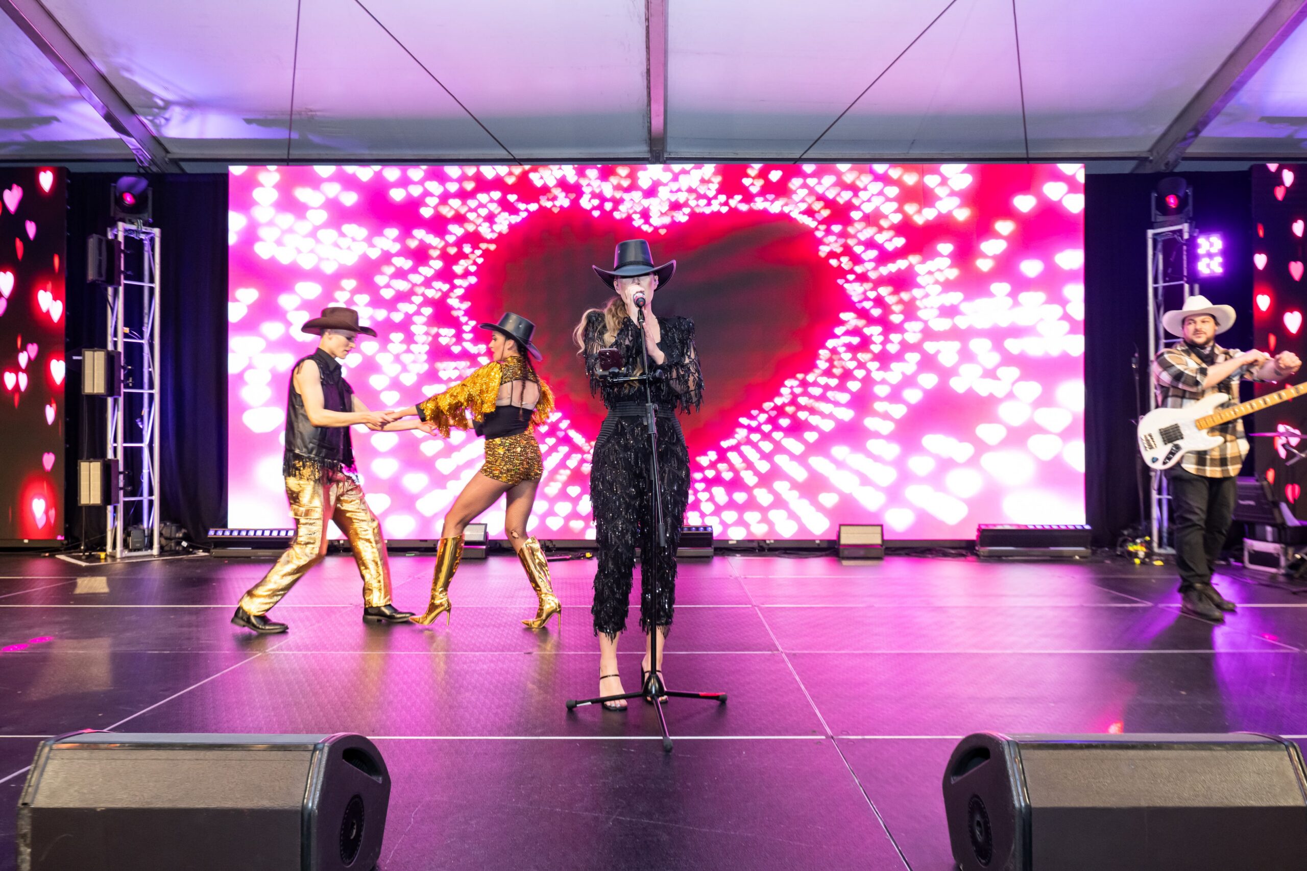 Live band and vocalist performing on stage with heart shaped LED screen backdrop - Encore Event Technologies