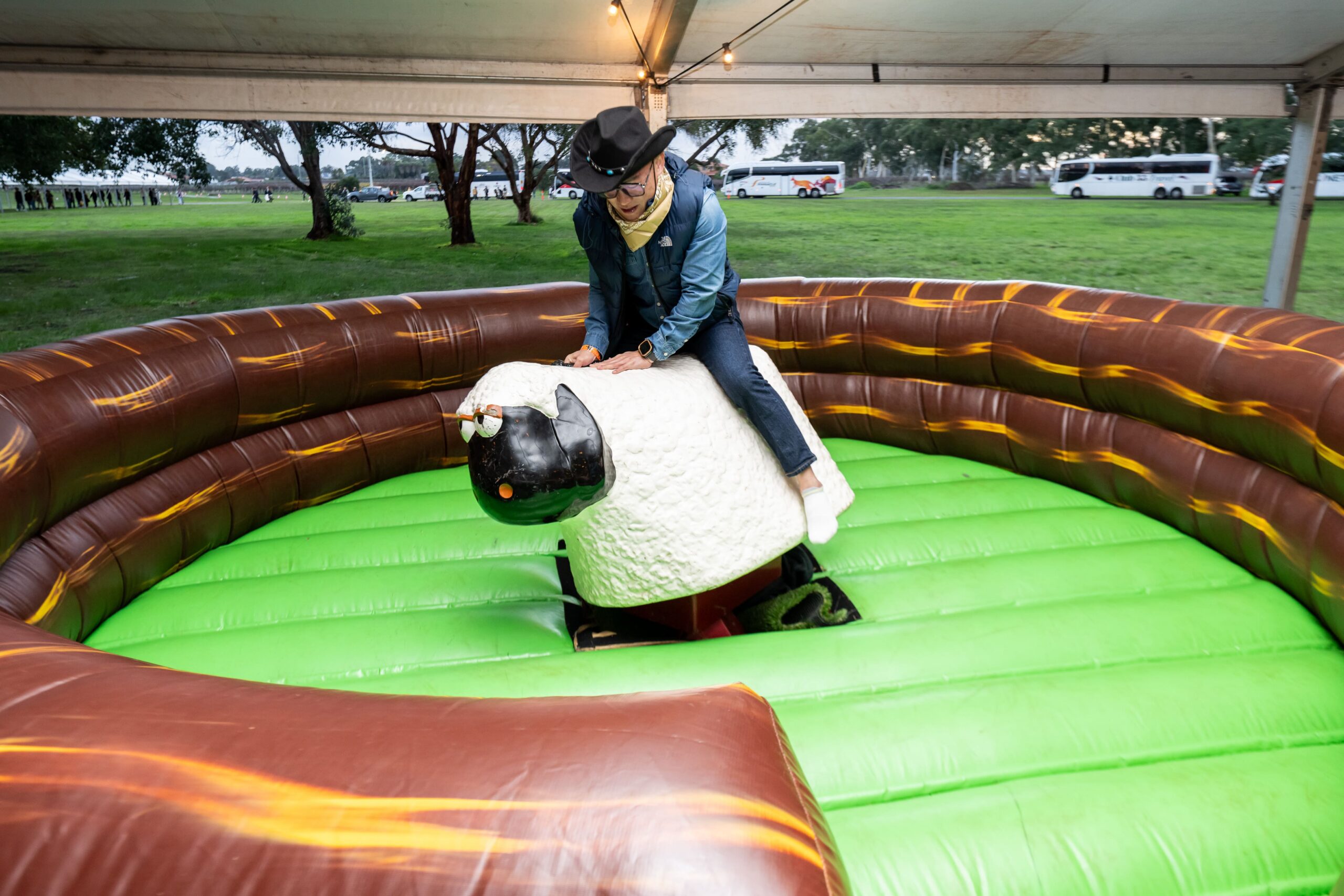 Mechanical rodeo attraction with participant riding inside a western themed inflatable arena - Encore Event Technologies