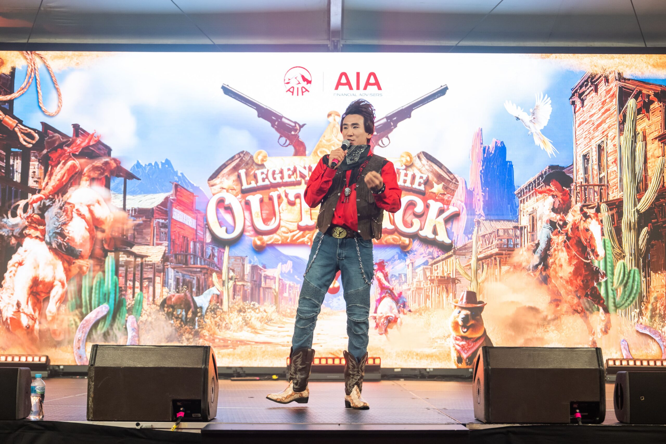 Live western themed stage performance with presenter in front of Legends of the Outback backdrop - Encore Event Technologies