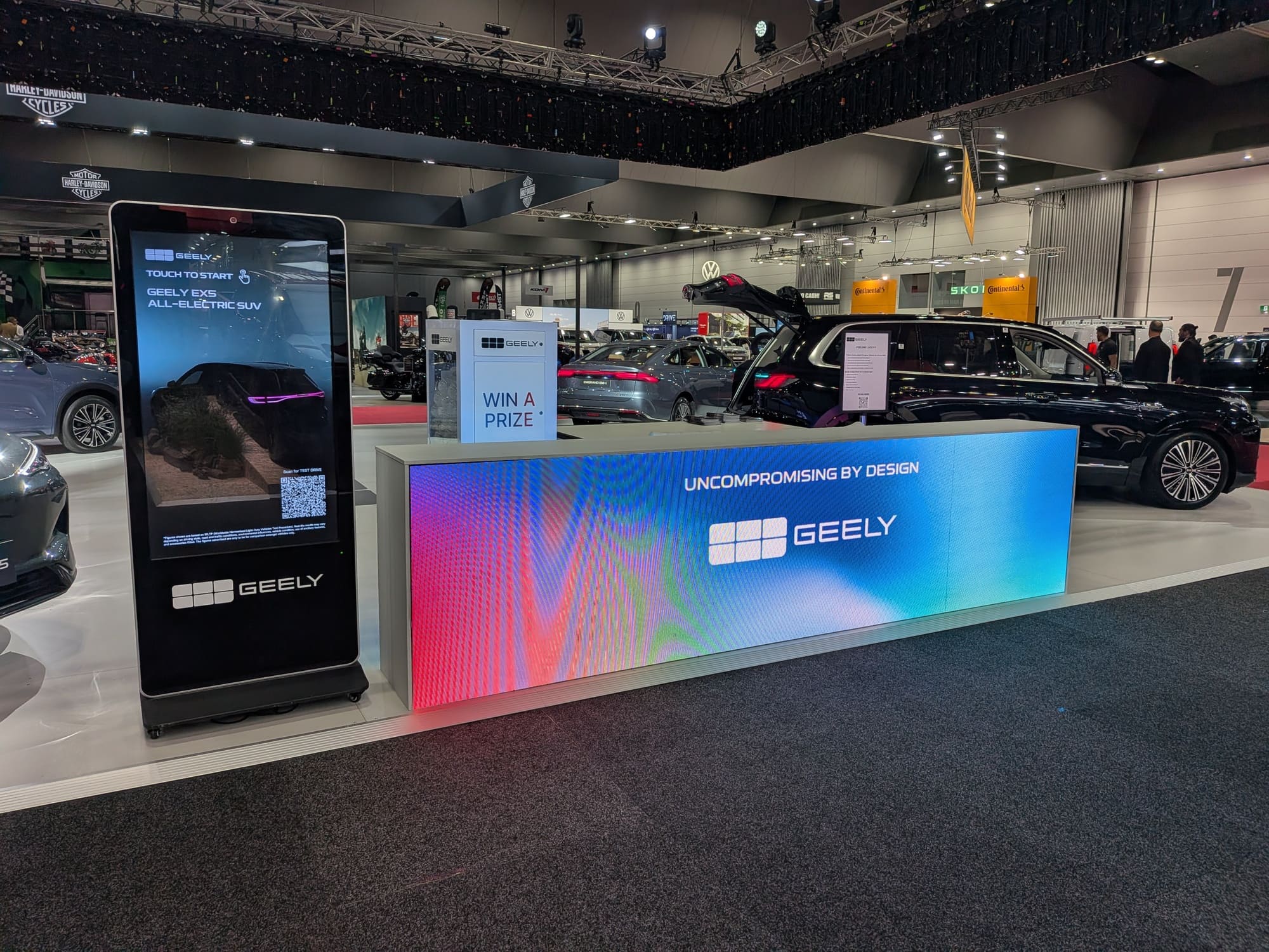 Geely exhibition booth with digital screen, prize sign and illuminated branding counter - Encore Event Technologies