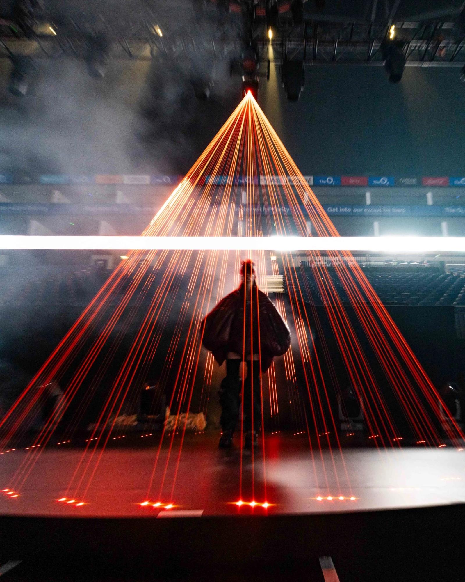 Runway performers surrounded by blue vertical lighting and large-scale digital screens - Encore Event Technologies