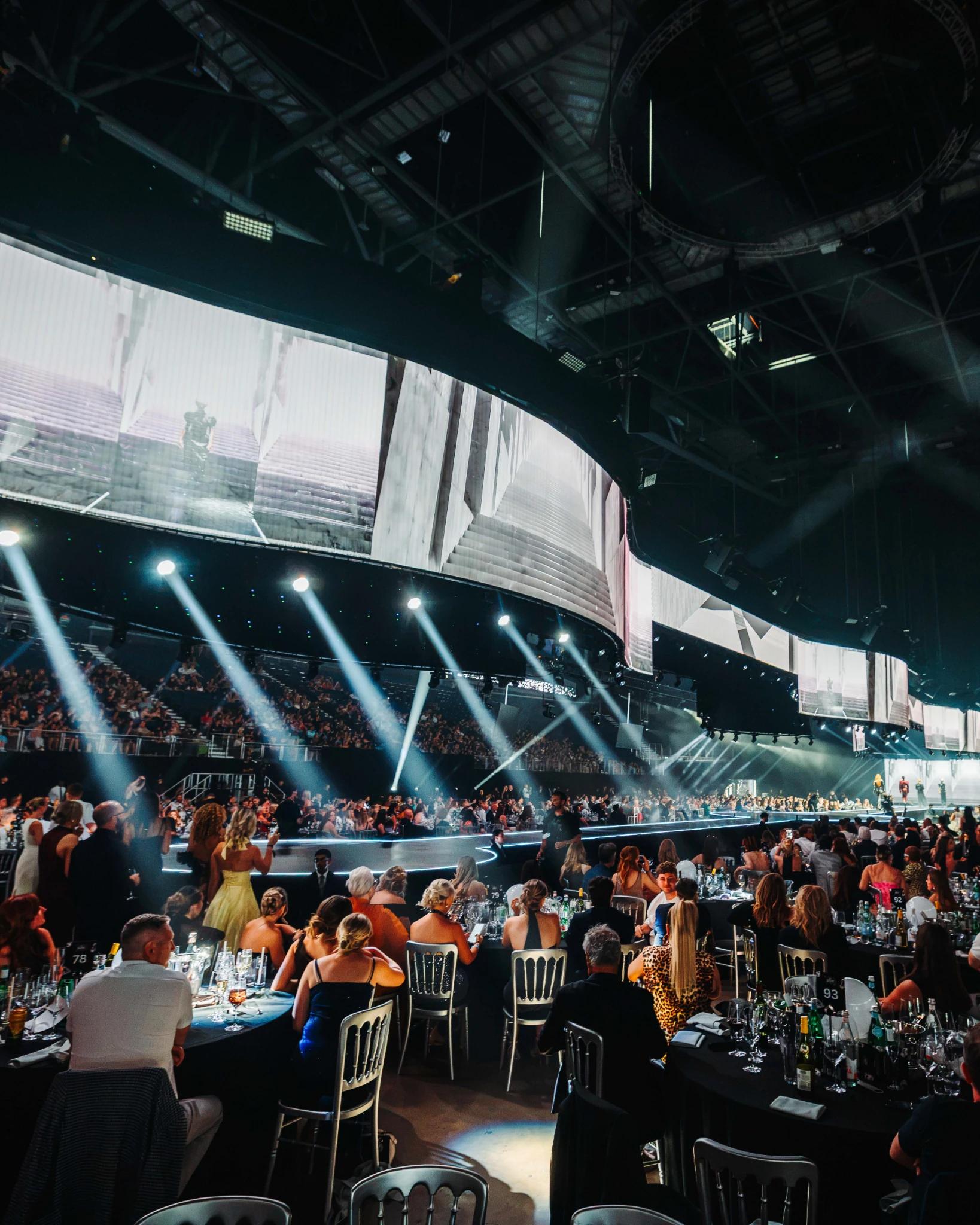 Runway presentation featuring large-scale digital displays and dramatic production lighting - Encore Event Technologies