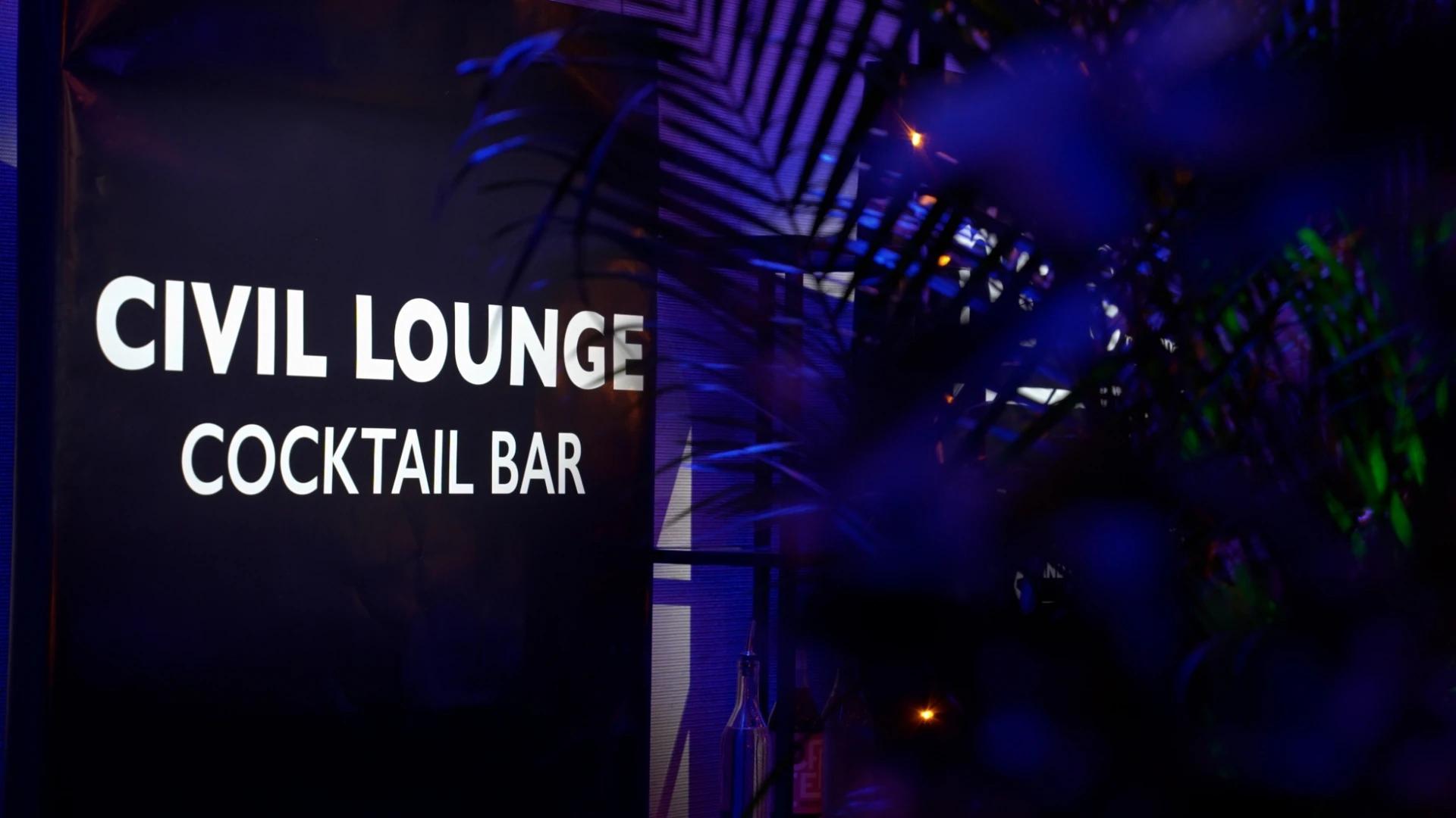 Close-up of illuminated Civil Lounge cocktail bar signage surrounded by event greenery - Encore APAC