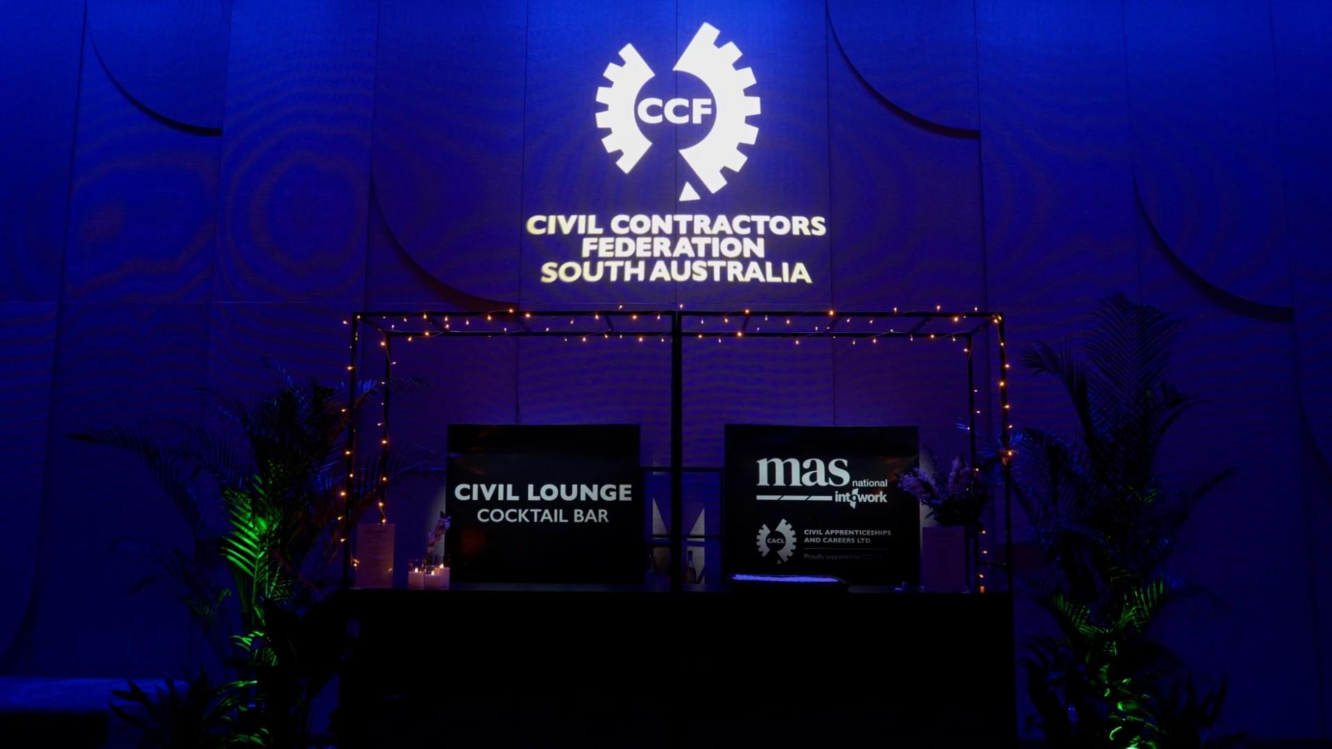 CCF South Australia logo projected above the Civil Lounge area with illuminated table centrepiece in the foreground - Encore APAC